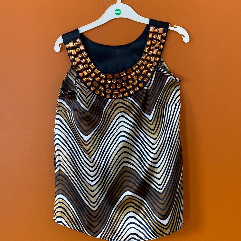 2/$20. She’s cool sleeveless blouse in size S with jewel like embellishments.